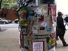 A pole covered in QR codes and stickers from the event SXSW 2013