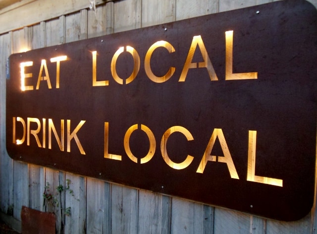 "Eat local, drink local" sign at Bastrop Brewhouse in Texas. Photo by Sheila Scarborough