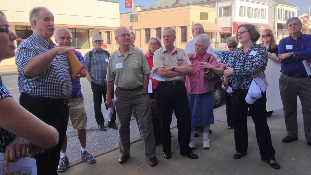 Group taking a walking tour of a downtown.