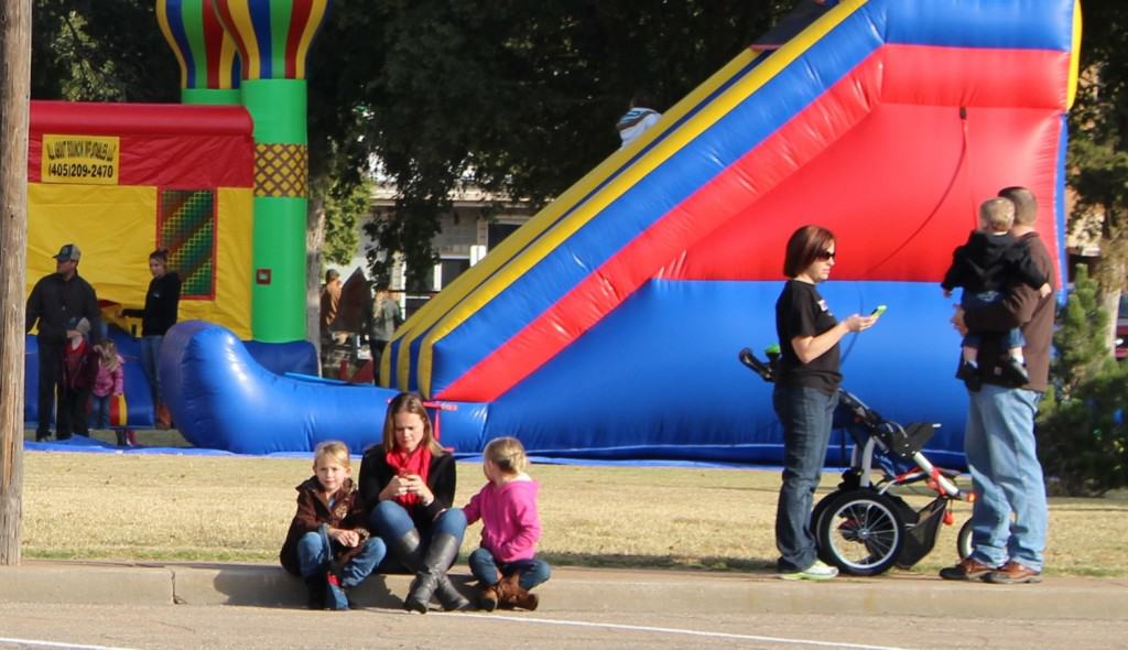 Parents and kids wait for a parade to start in downtown Alva, Oklahoma. Photo by Becky McCray