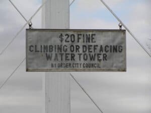 Sign: 20 fine climbing or defacing water tower