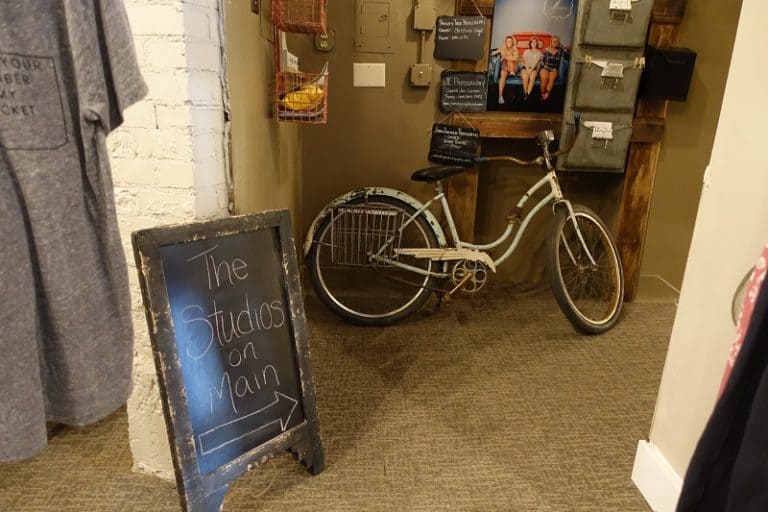 A sign in a retail store points to more businesses downstair