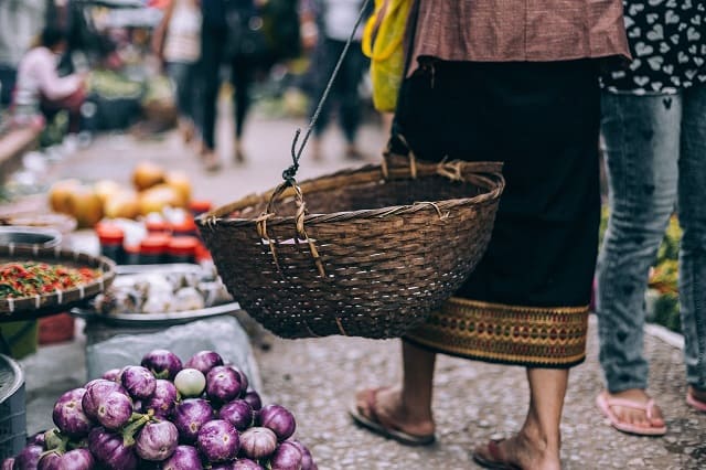 Shopping a market carrying a basket
