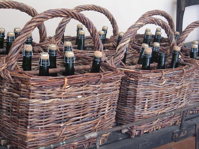 Basket with sparkling wine bottles