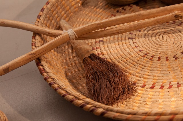 Basket with a tasseled brush