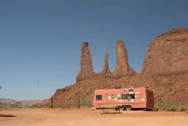 Near the iconic sandstone towers in Monument Valley, a concession trailer offers food, with a picnic table out front. 