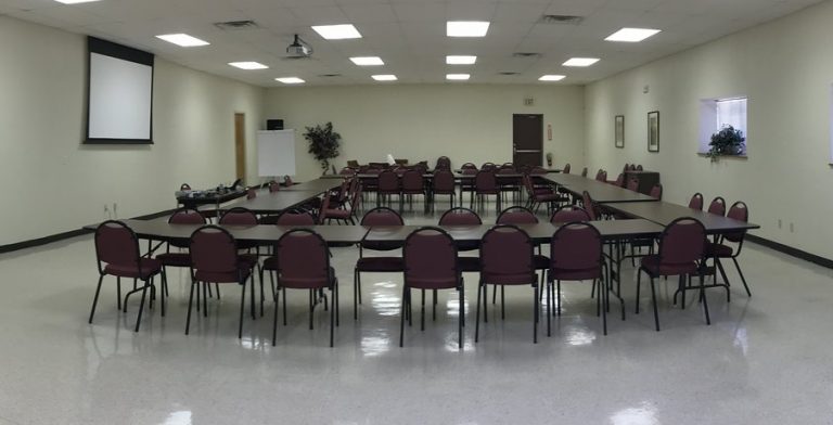 Chairs and tables set up for a town board or city council type meeting