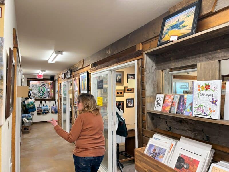 A woman is guiding you around a converted barn, filled with local art, craft and gifts. 