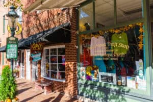 A busy window and storefront of a thrift shop in downtown Berlin, Maryland.