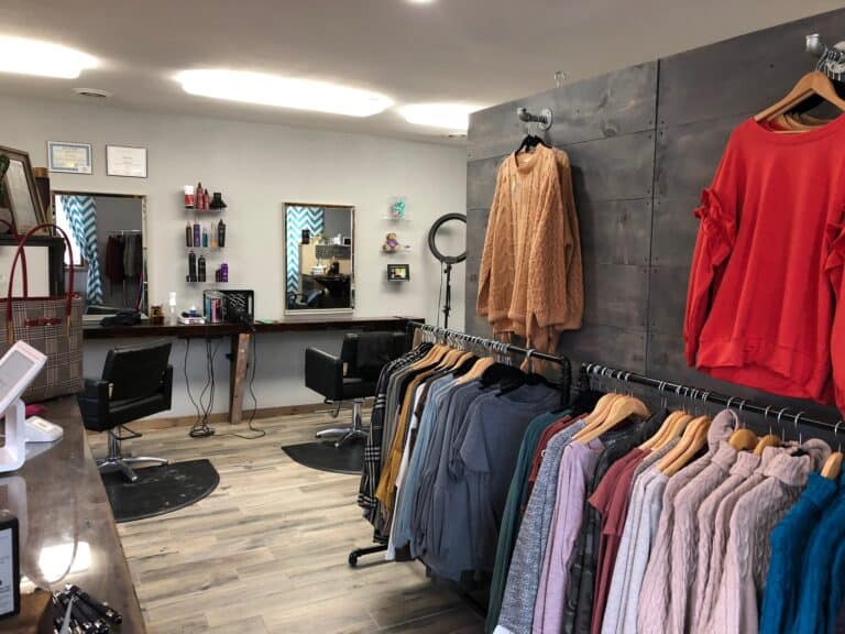 Clothing displayed on one wall, with a salon in the back.