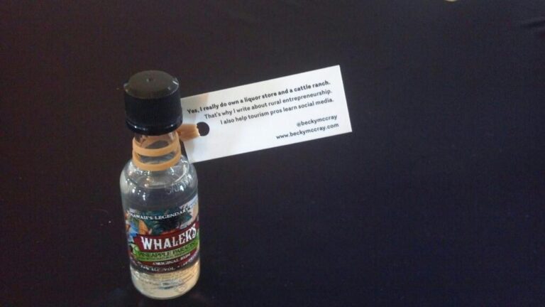 A mini bottle of Whalers Rum with a mini card that says, "Yes I really run a liquor store" and listing my social media handles