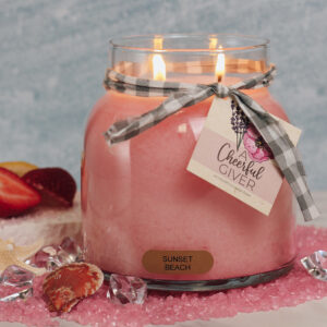 Small candle in a glass jar with two wicks and a pretty ribbon